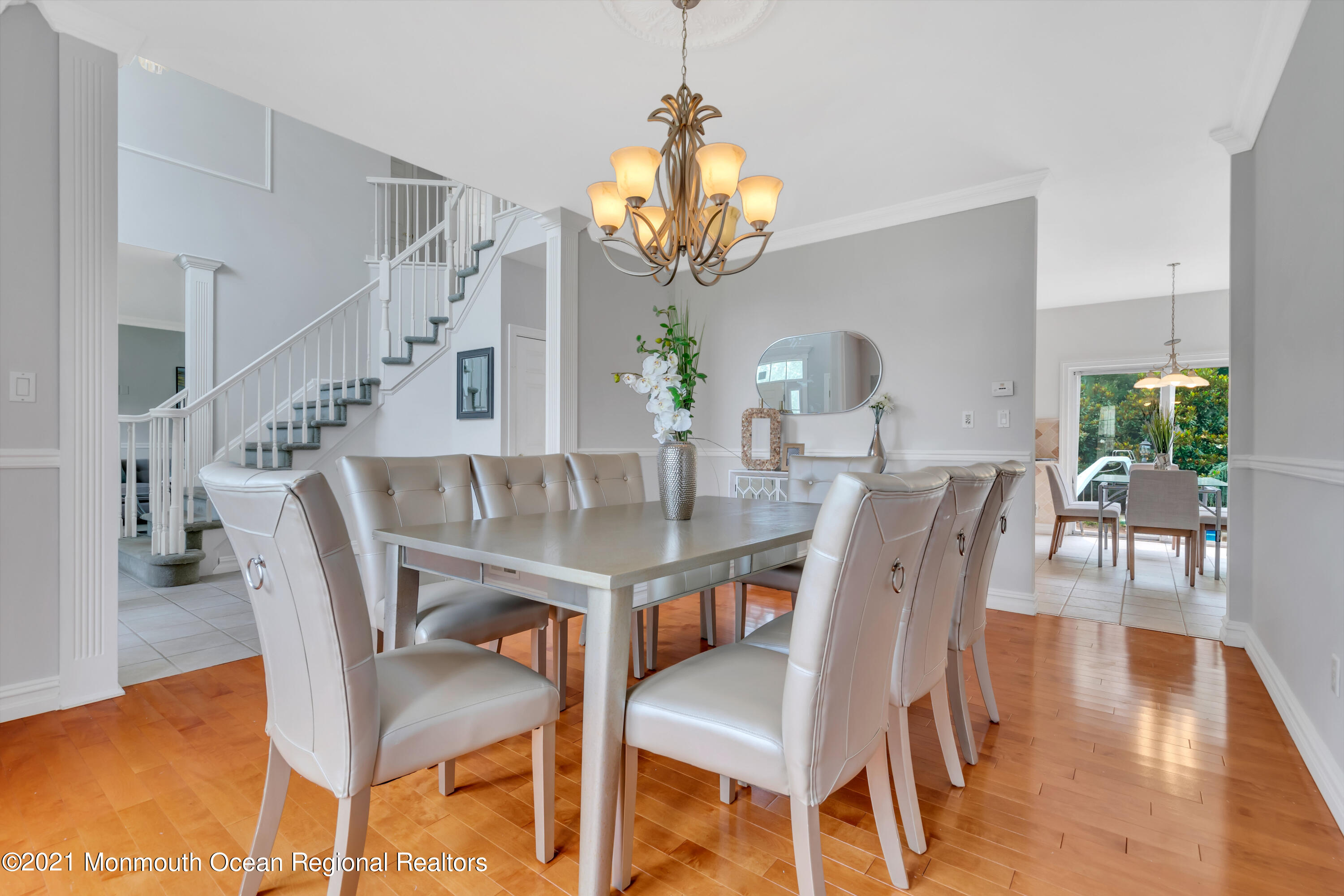 20 Highland Drive Jackson, NJ 08527 - Photo 11 of 62 a dining room with wooden floor a chandelier a wooden table and chairs