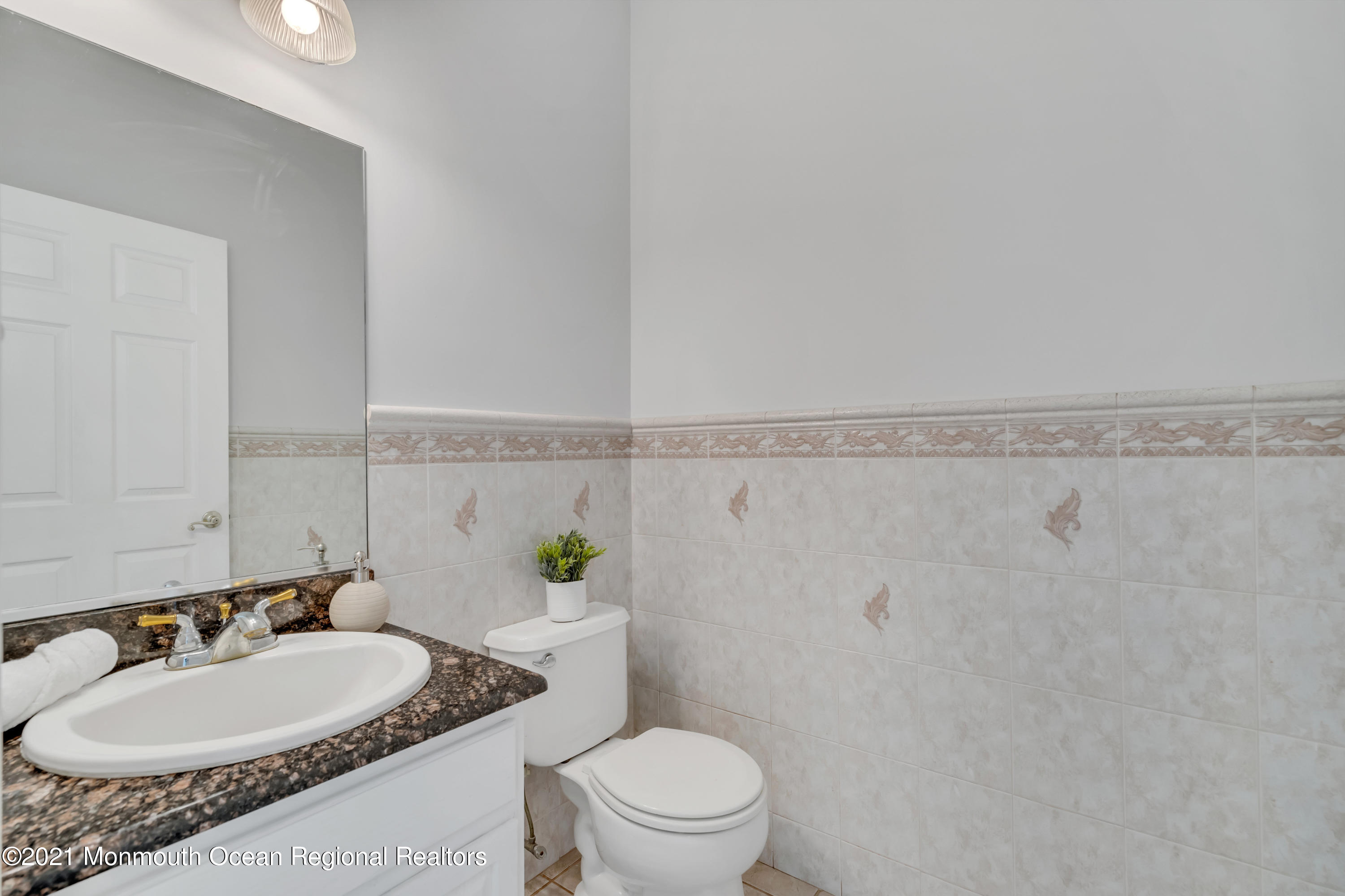 20 Highland Drive Jackson, NJ 08527 - Photo 26 of 62 a bathroom with a granite countertop sink a mirror and a toilet