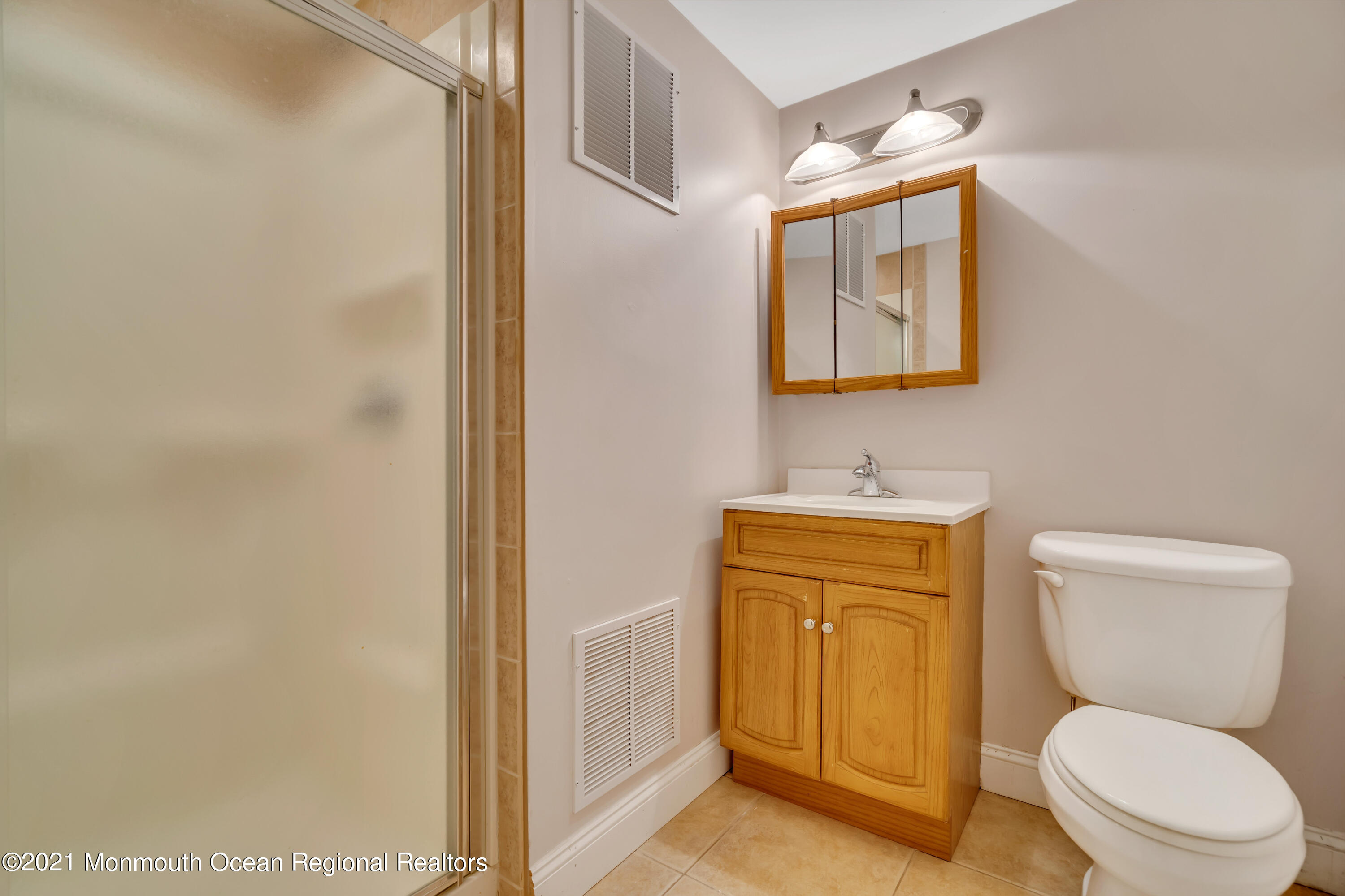 20 Highland Drive Jackson, NJ 08527 - Photo 41 of 62 a bathroom with a toilet a sink and a mirror