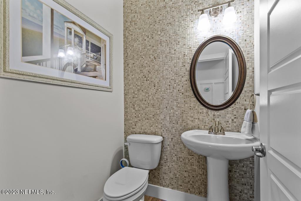 311 E Street St. Augustine, FL 32080 - Photo 14 of 40 a bathroom with a toilet sink and mirror