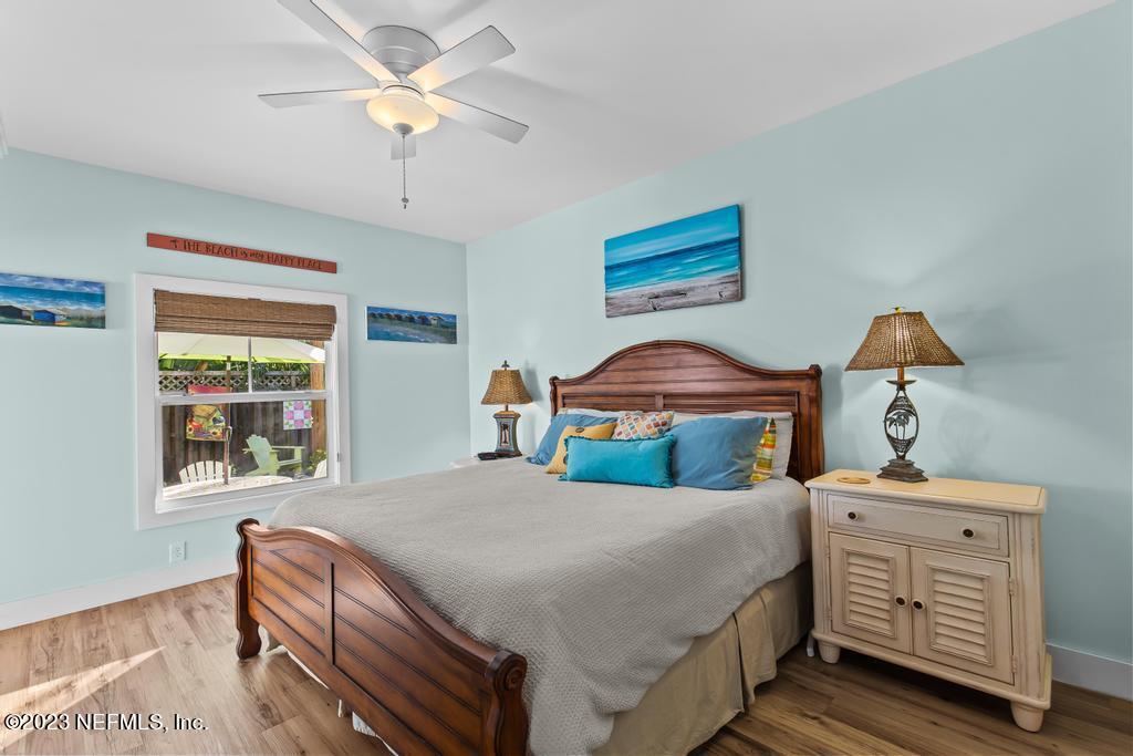 311 E Street St. Augustine, FL 32080 - Photo 15 of 40 a bedroom with a bed and a chandelier