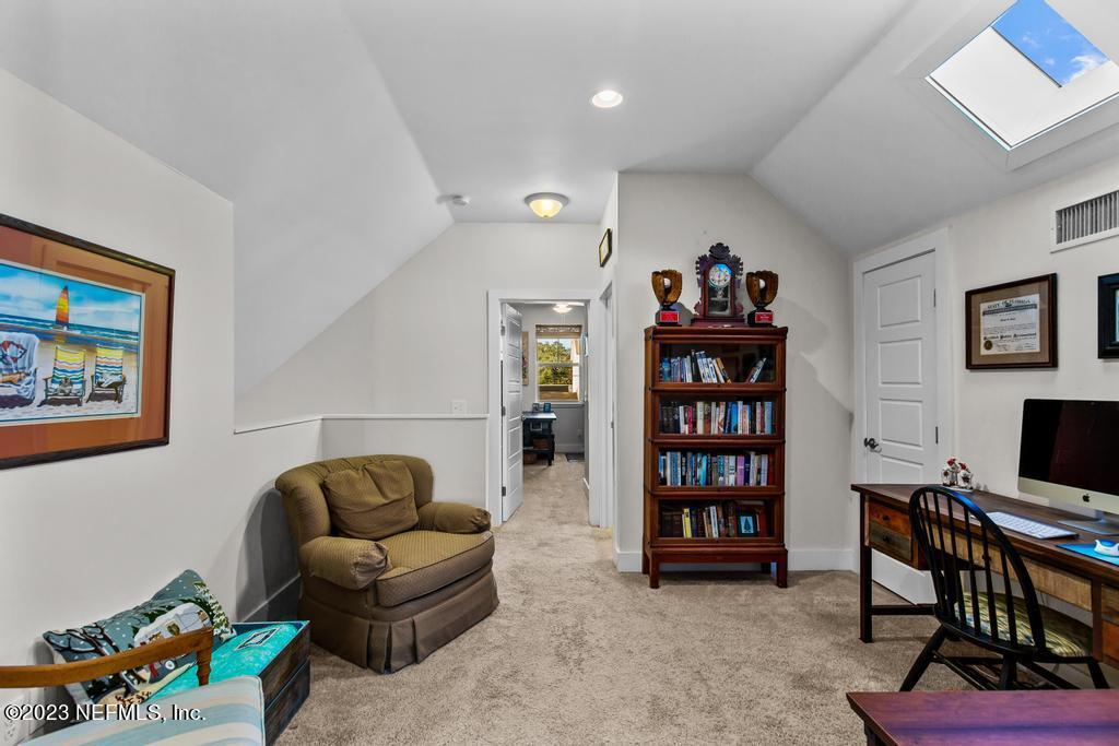 311 E Street St. Augustine, FL 32080 - Photo 21 of 40 a living room with furniture a bookshelf and a bookshelf