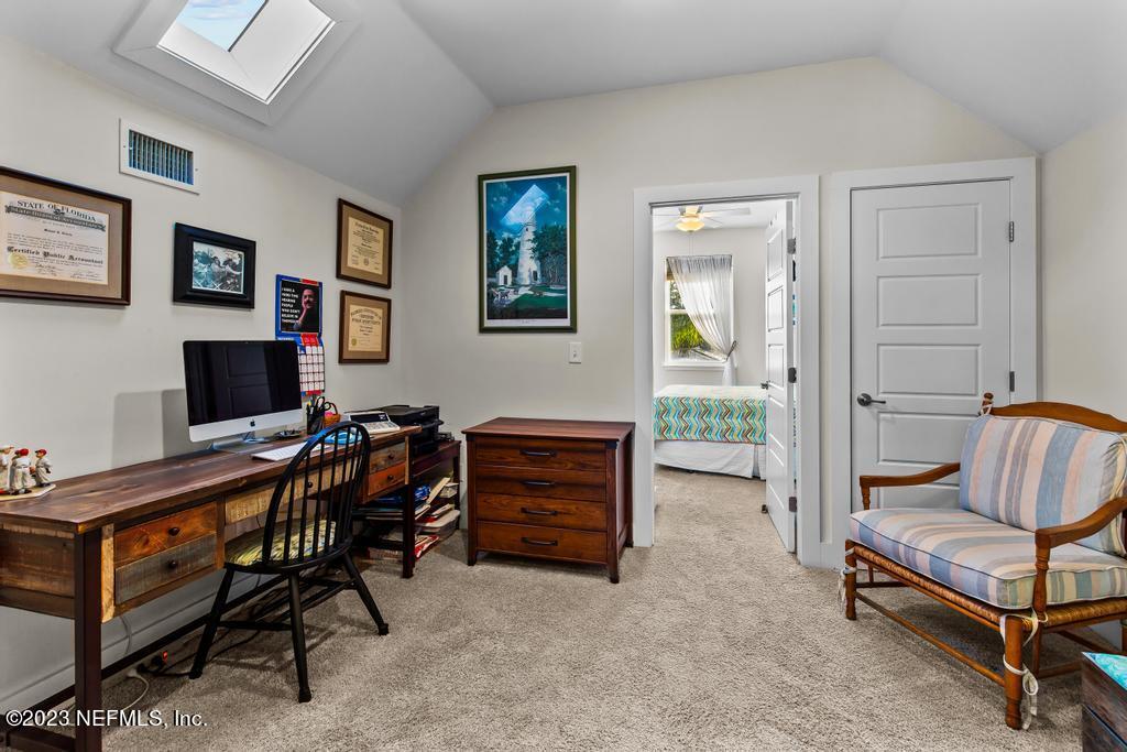 311 E Street St. Augustine, FL 32080 - Photo 22 of 40 a living room with furniture and a flat screen tv