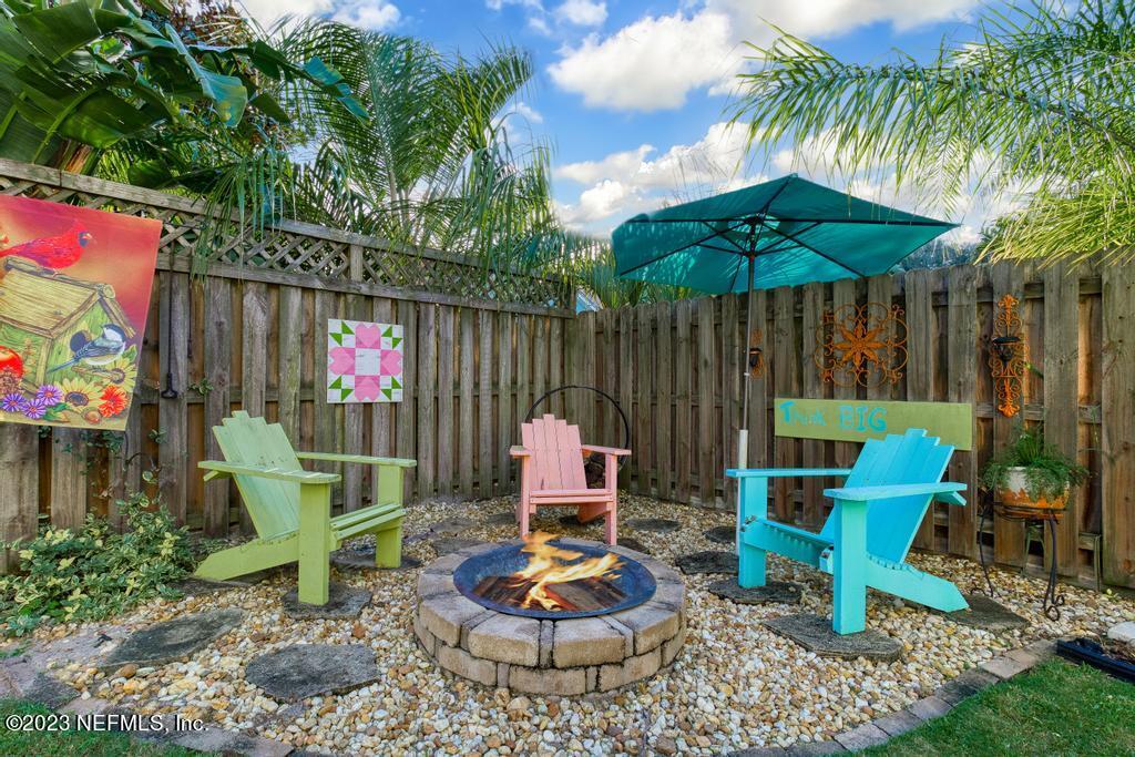 311 E Street St. Augustine, FL 32080 - Photo 32 of 40 a backyard of a house with table and chairs