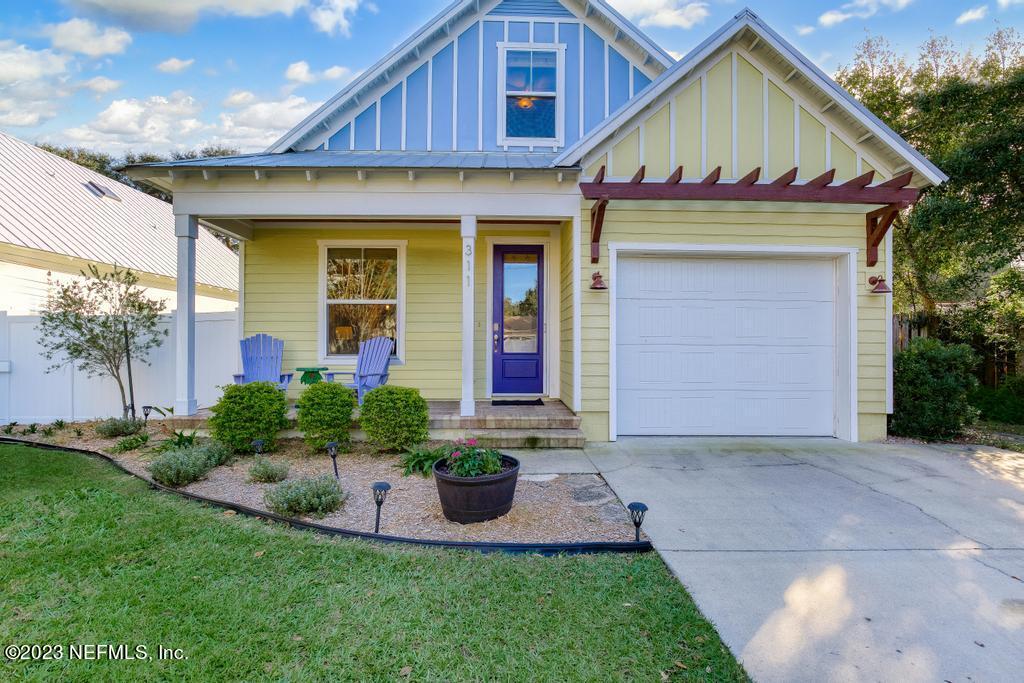 311 E Street St. Augustine, FL 32080 - Photo 4 of 40 a front view of a house with a yard and potted plants