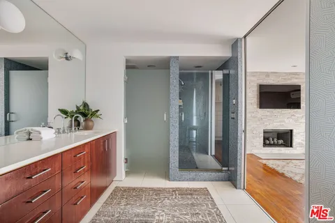 a spacious bathroom with a granite countertop sink and a mirror