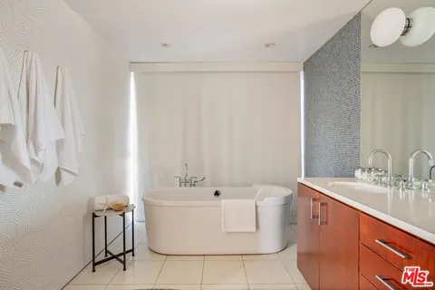 a bathroom with a sink a mirror and a bathtub