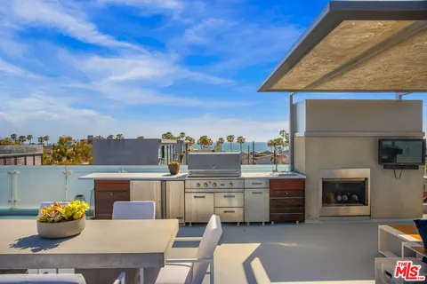 a view of a dining table and chairs in the patio