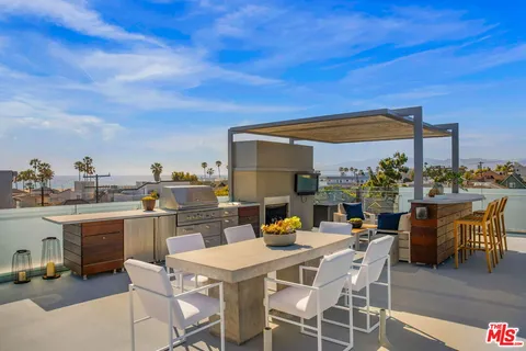 a view of a patio with couches dining table and chairs