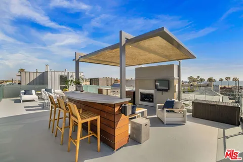 a view of a terrace with couches and city view
