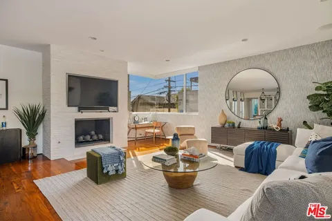 a living room with fireplace furniture and a flat screen tv
