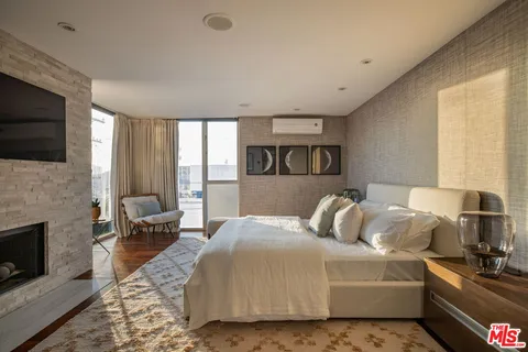 a bedroom with a bed and a television