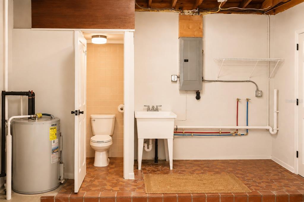 1559 Barry Road Clearwater, FL 33756 - Photo 16 of 20 a bathroom with a sink toilet and shower