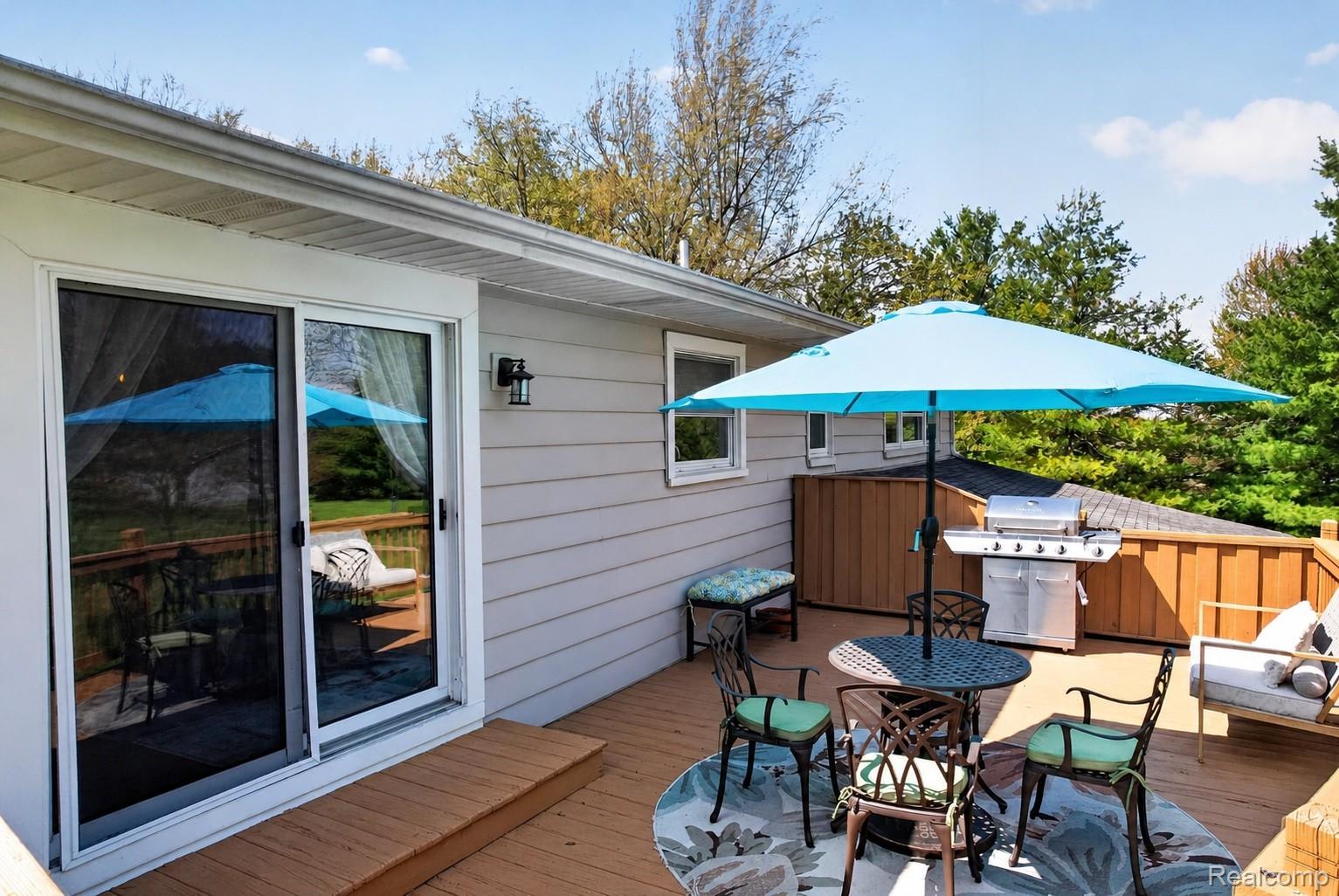 1180 North Hurd Road Ortonville, MI 48462 - Photo 11 of 43 Deck with grilling area and outdoor dining space