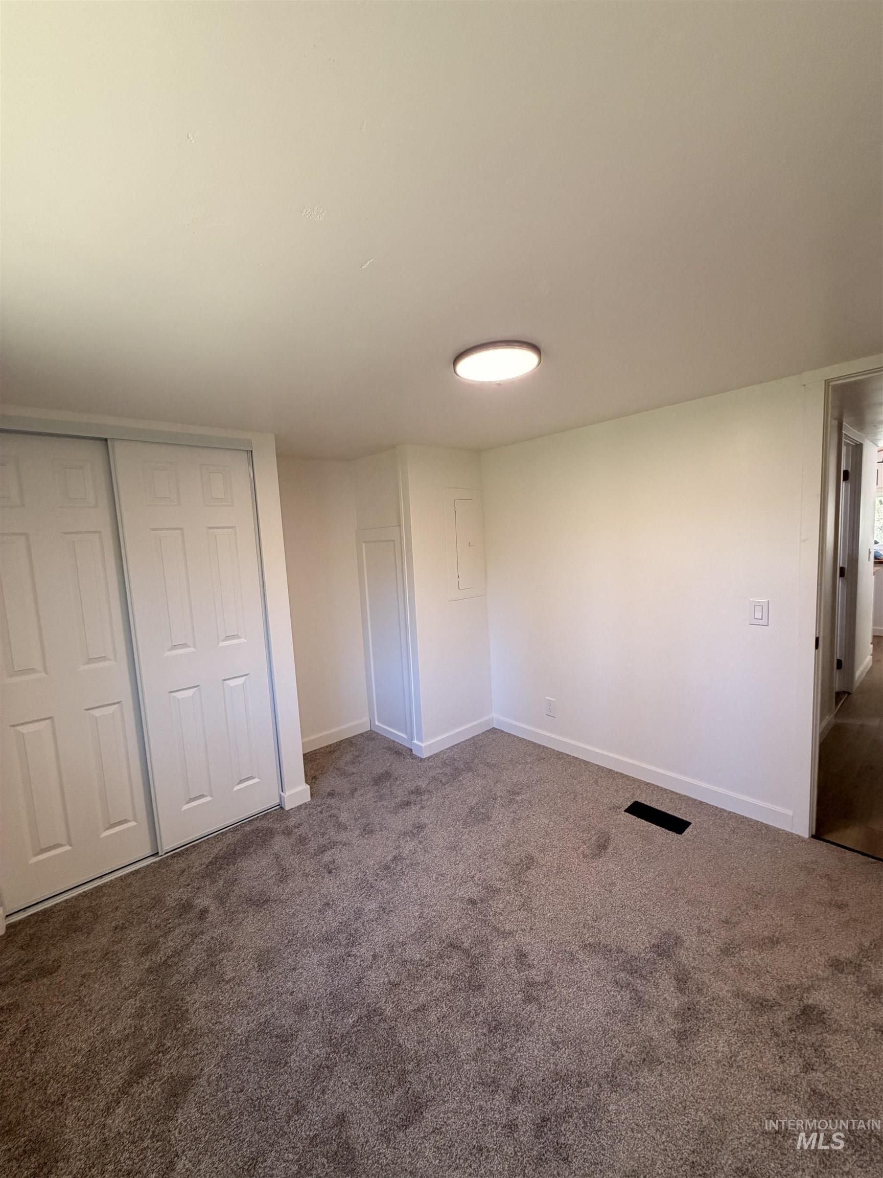 151 View Road Kamiah, ID 83536 - Photo 24 of 49 Room featuring neutral-toned carpet flooring, white walls, and a flush-mount ceiling light