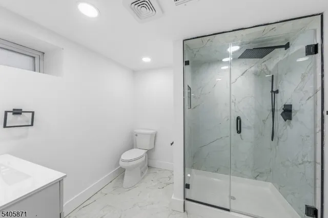 a white bath tub sitting in a bathroom next to a window