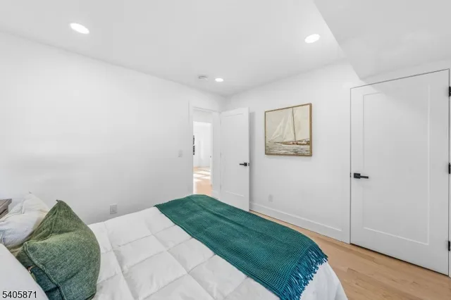 a spacious bedroom with a large bed and a large window