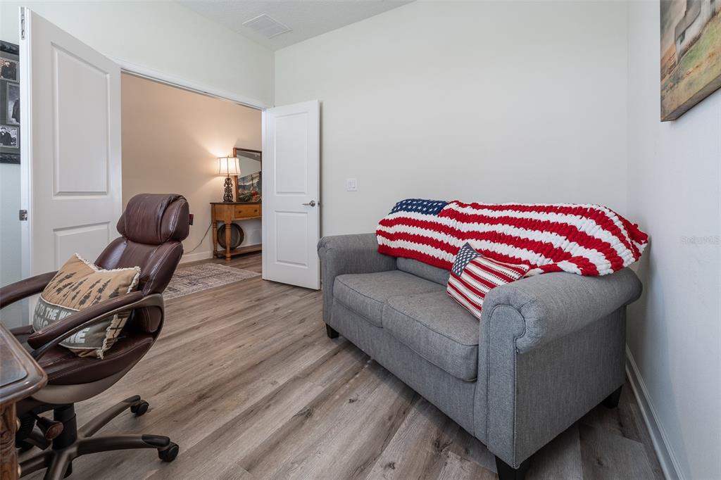 9224 Southwest 60th Ct Road Ocala, FL 34476 - Photo 36 of 55 a living room with furniture and a wooden floor