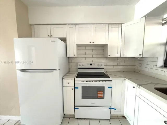 a view of a kitchen with washer and dryer