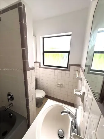 a bathroom with a sink toilet and tub