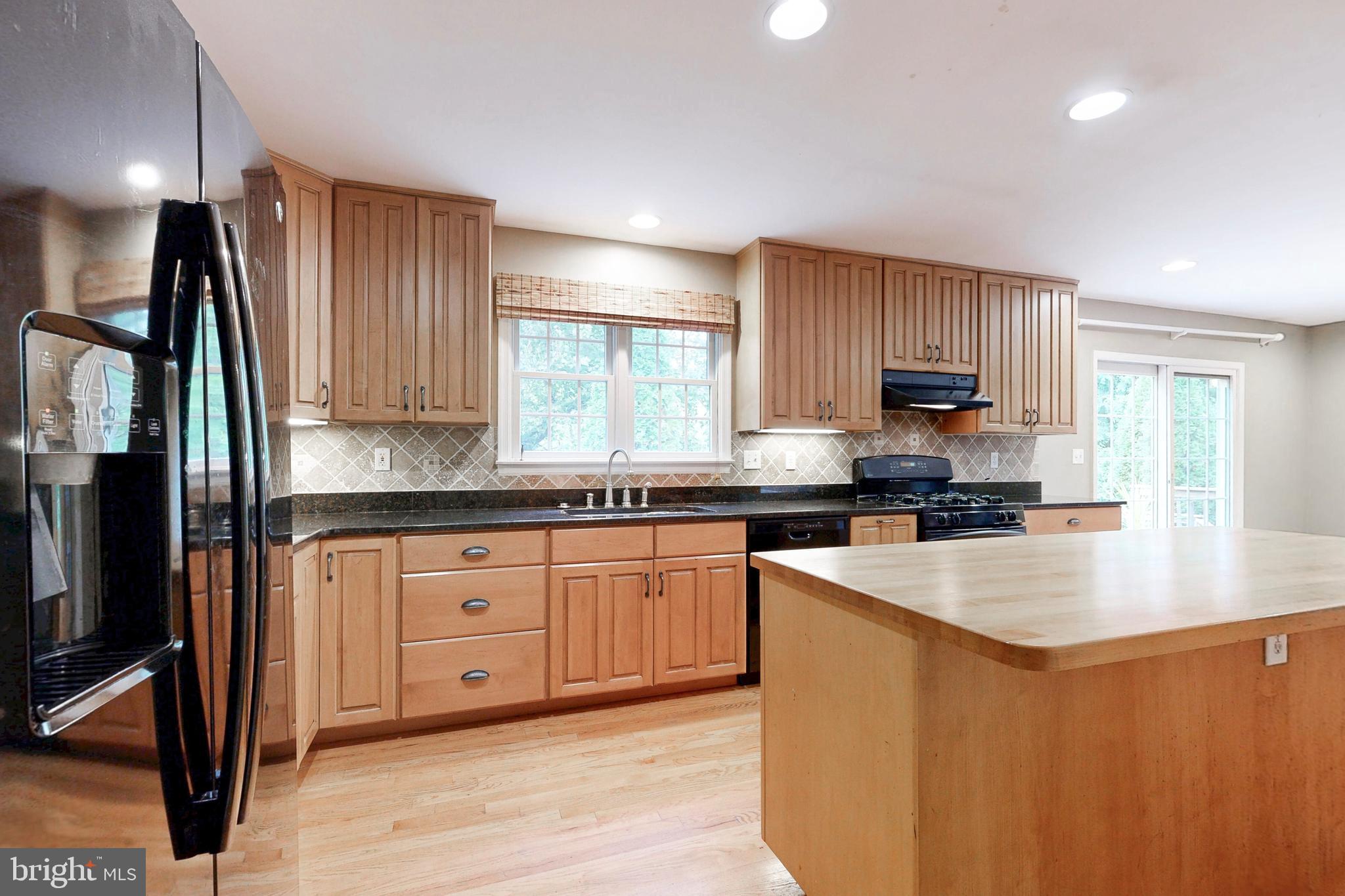 7920 Springway Road Baltimore, MD 21204 - Photo 12 of 49 a kitchen with stainless steel appliances granite countertop a sink a stove and refrigerator