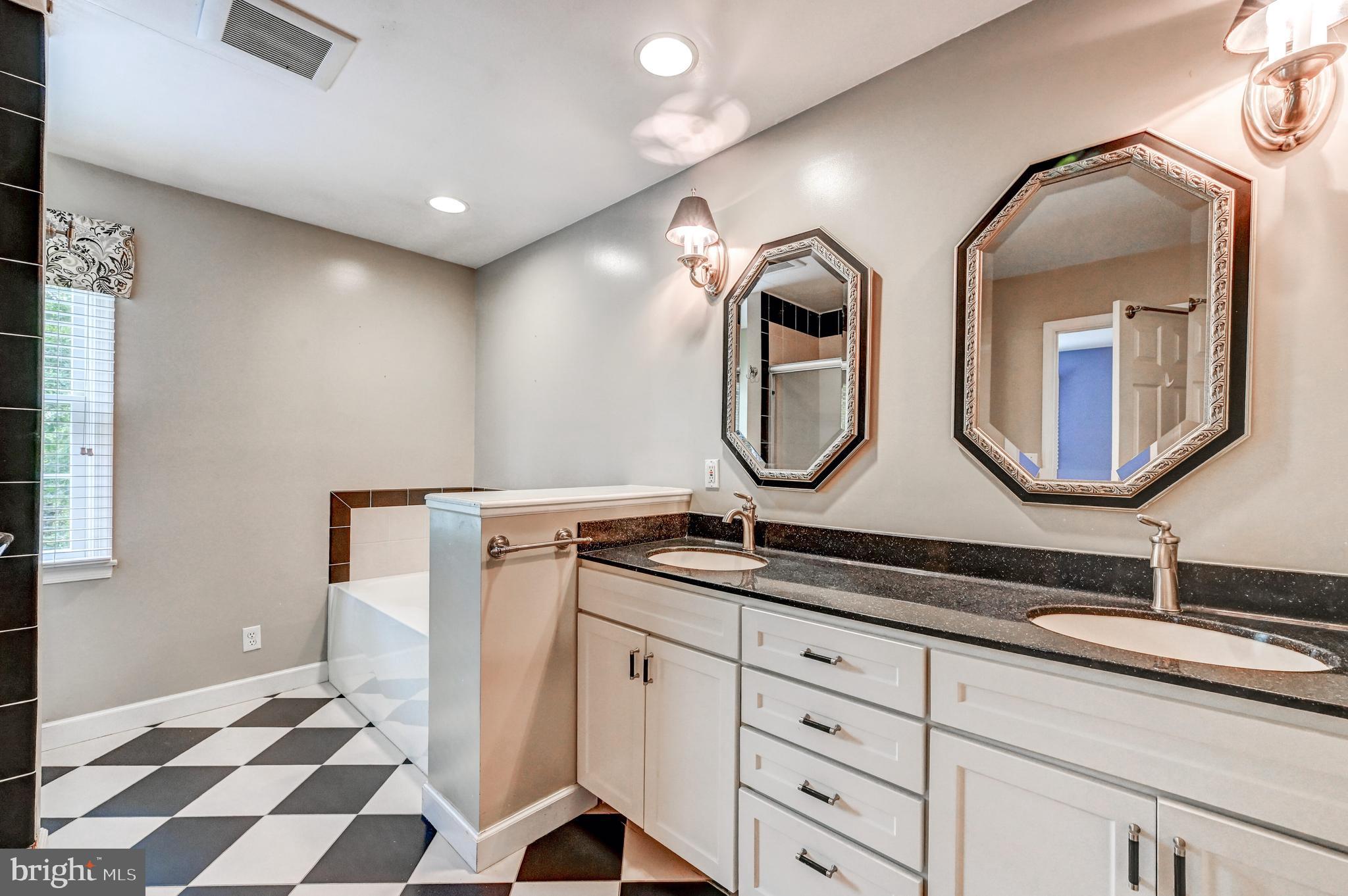 7920 Springway Road Baltimore, MD 21204 - Photo 20 of 49 a bathroom with a double vanity sink and a mirror