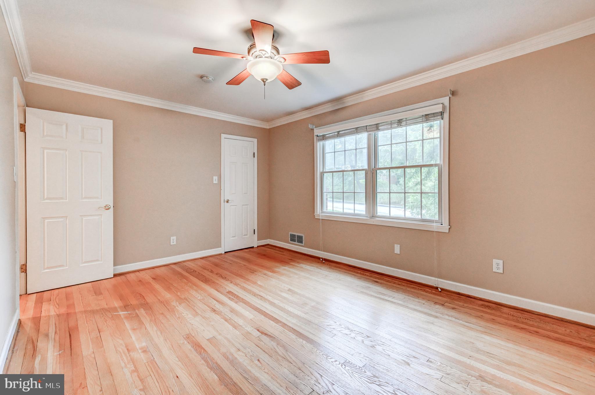 7920 Springway Road Baltimore, MD 21204 - Photo 23 of 49 a view of an empty room with wooden floor and a window
