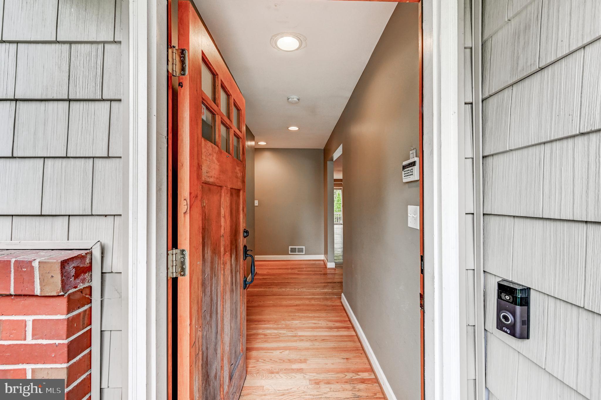 7920 Springway Road Baltimore, MD 21204 - Photo 5 of 49 a view of a hallway with wooden cabinets and staircase