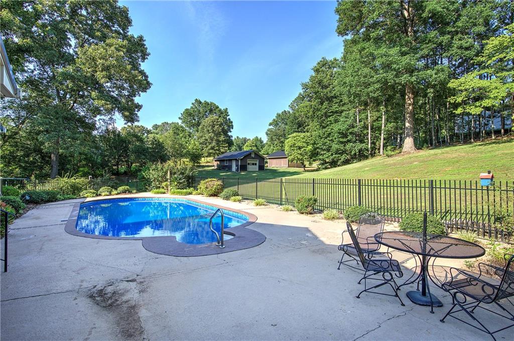 408 Mac Johnson Road Northwest Cartersville, GA 30121 - Photo 64 of 79 a view of a swimming pool with a patio