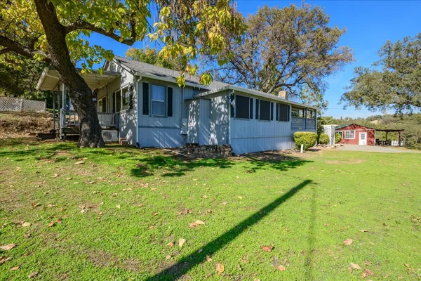 a view of a house with pool and a yard