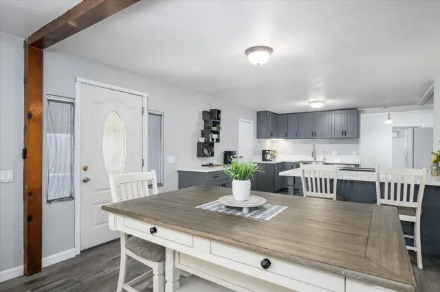 a kitchen with a table chairs refrigerator and cabinets