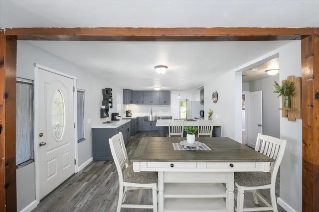 a dining room with furniture and wooden floor