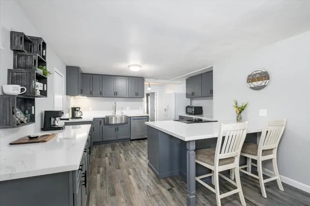 a large kitchen with a table and chairs in it
