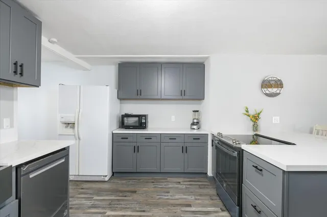 a kitchen with a sink cabinets and appliances