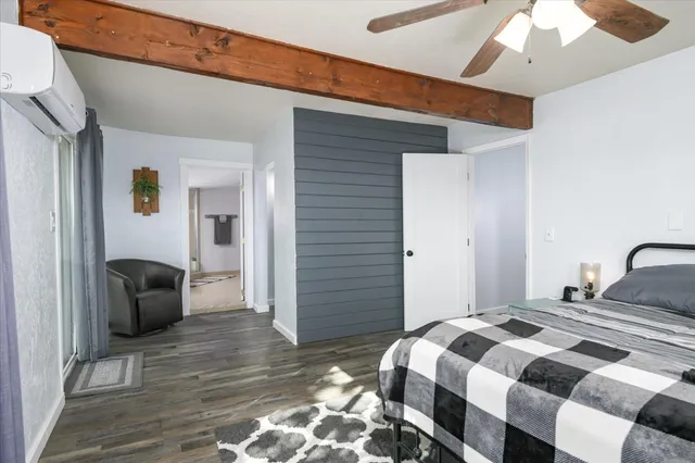 a bedroom with a bed and a couch