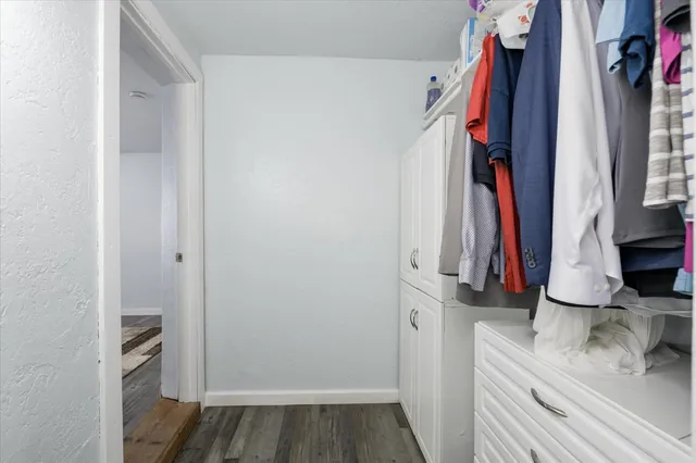 a view of walk in closet with clothes