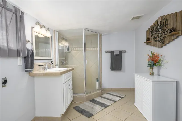 a bathroom with a sink a mirror and a shower