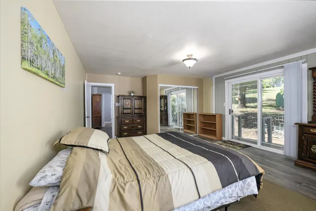 a bedroom with a large bed and a large window