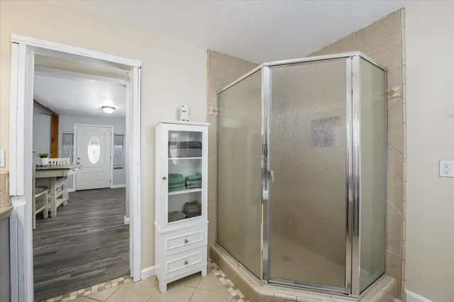a bathroom with a glass shower door