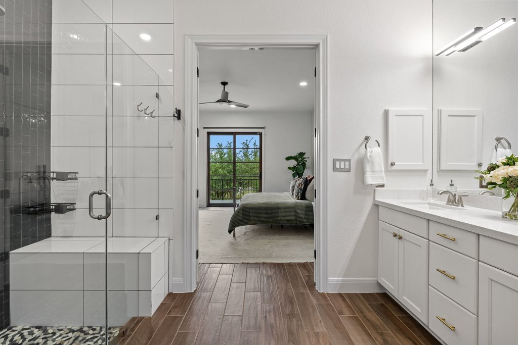17641 Stratus Cove Dripping Springs, TX 78620 - Photo 23 of 40 a en suite bathroom with a sink a mirror and shower