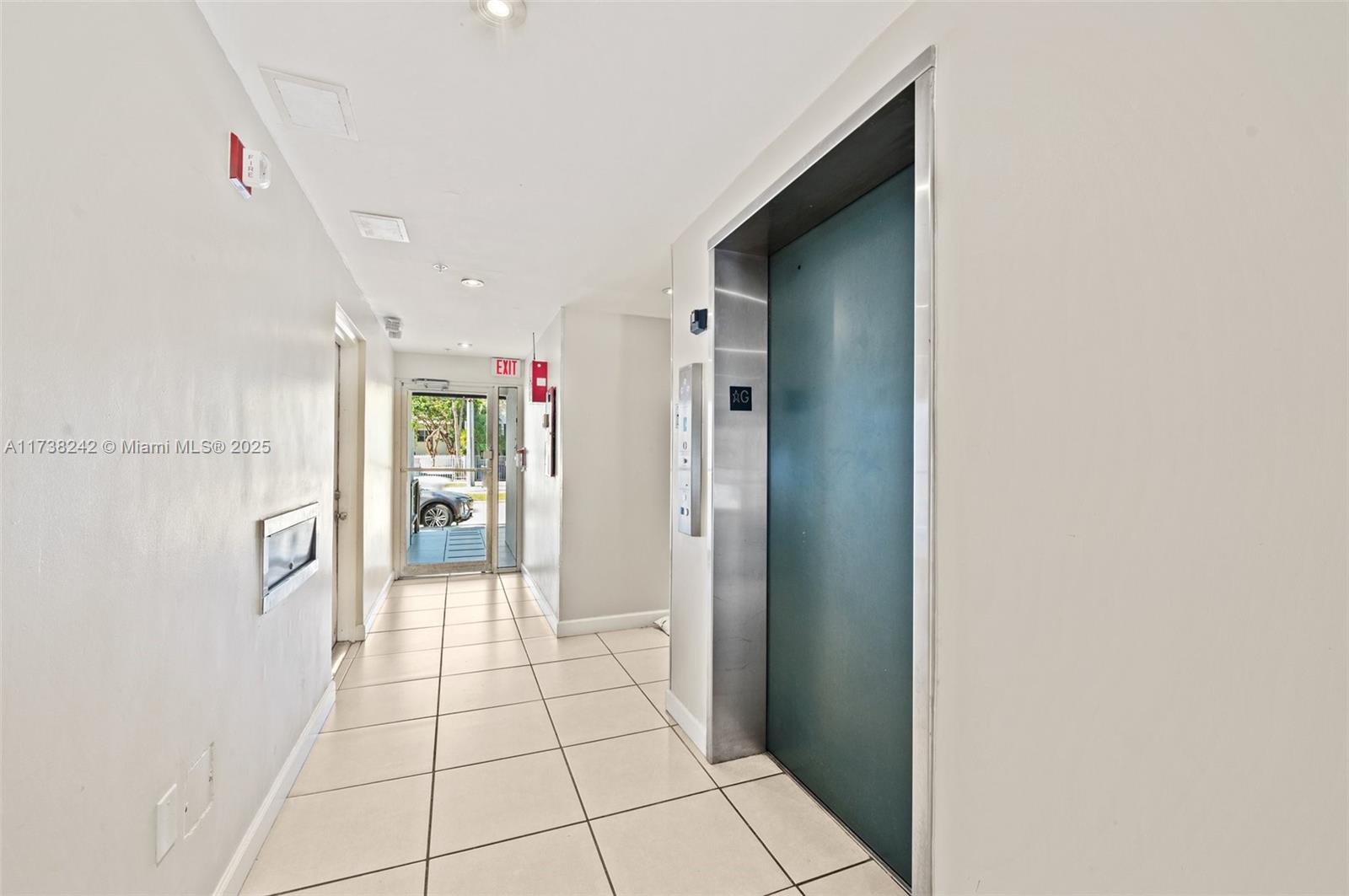 3051 Southwest 27th Avenue, Unit 302 Miami, FL 33133 - Photo 17 of 19 a hallway with sliding door and entryway