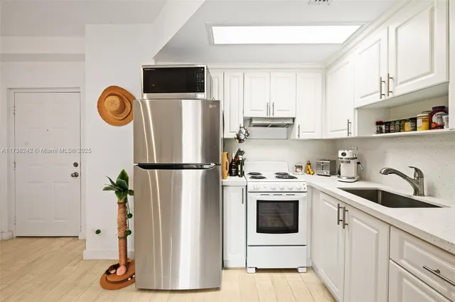 a kitchen with a refrigerator and a stove