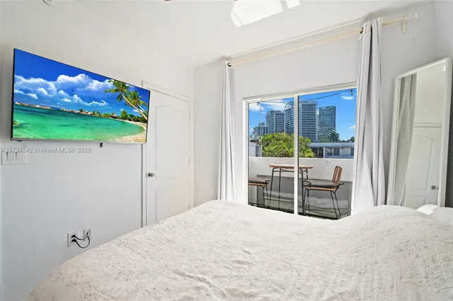 a bedroom with a bed and glass window