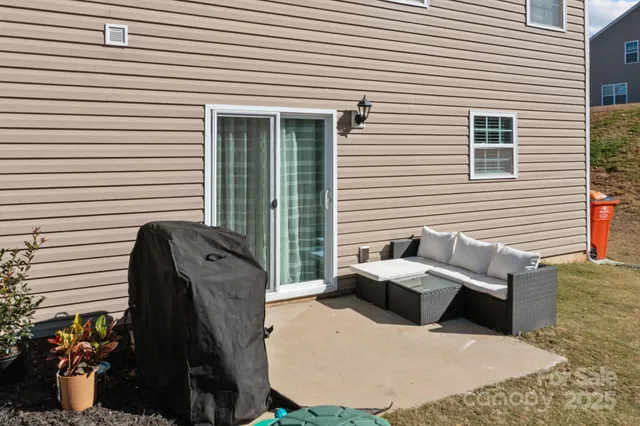 a view of a white house with many windows next to a road