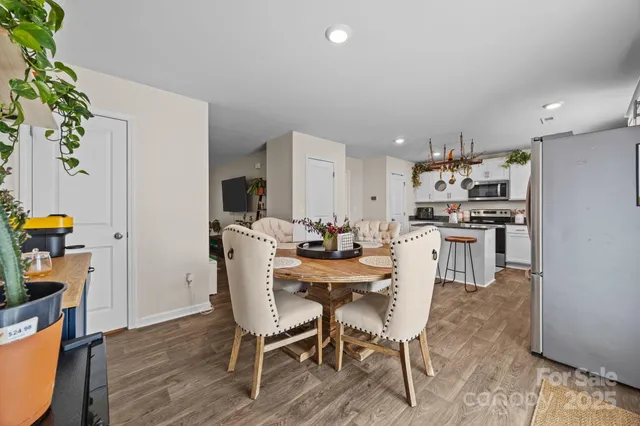 a kitchen with stainless steel appliances a chandelier and refrigerator