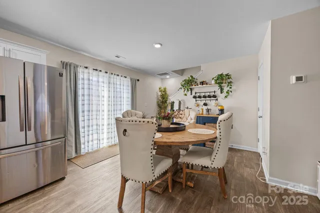 a kitchen with stainless steel appliances granite countertop a white cabinets stove a sink and dishwasher