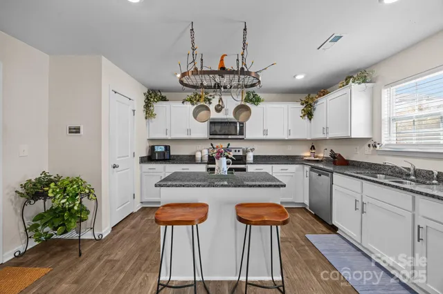 a kitchen with a stove a sink and a microwave