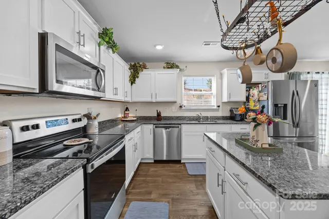 a stove top oven sitting inside of a kitchen