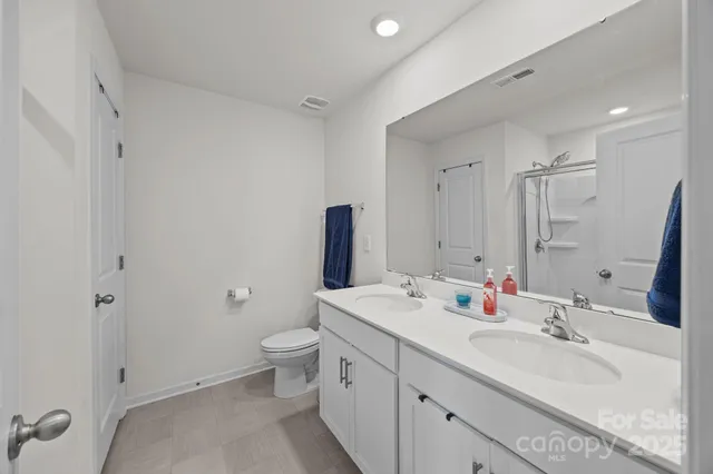 a view of walk in closet with clothes