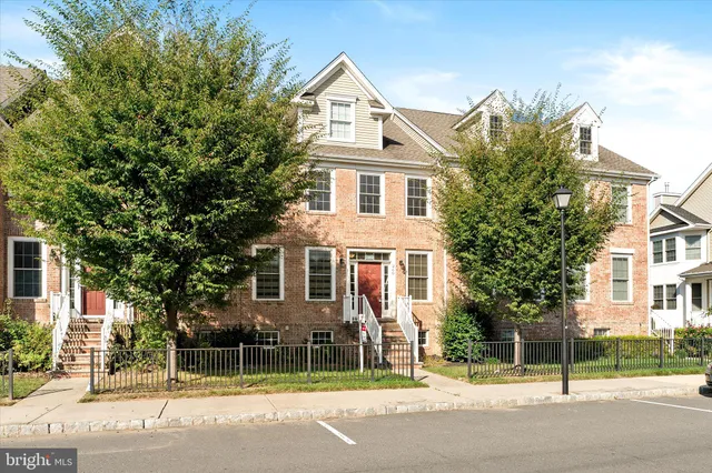 a view of a white house with a street